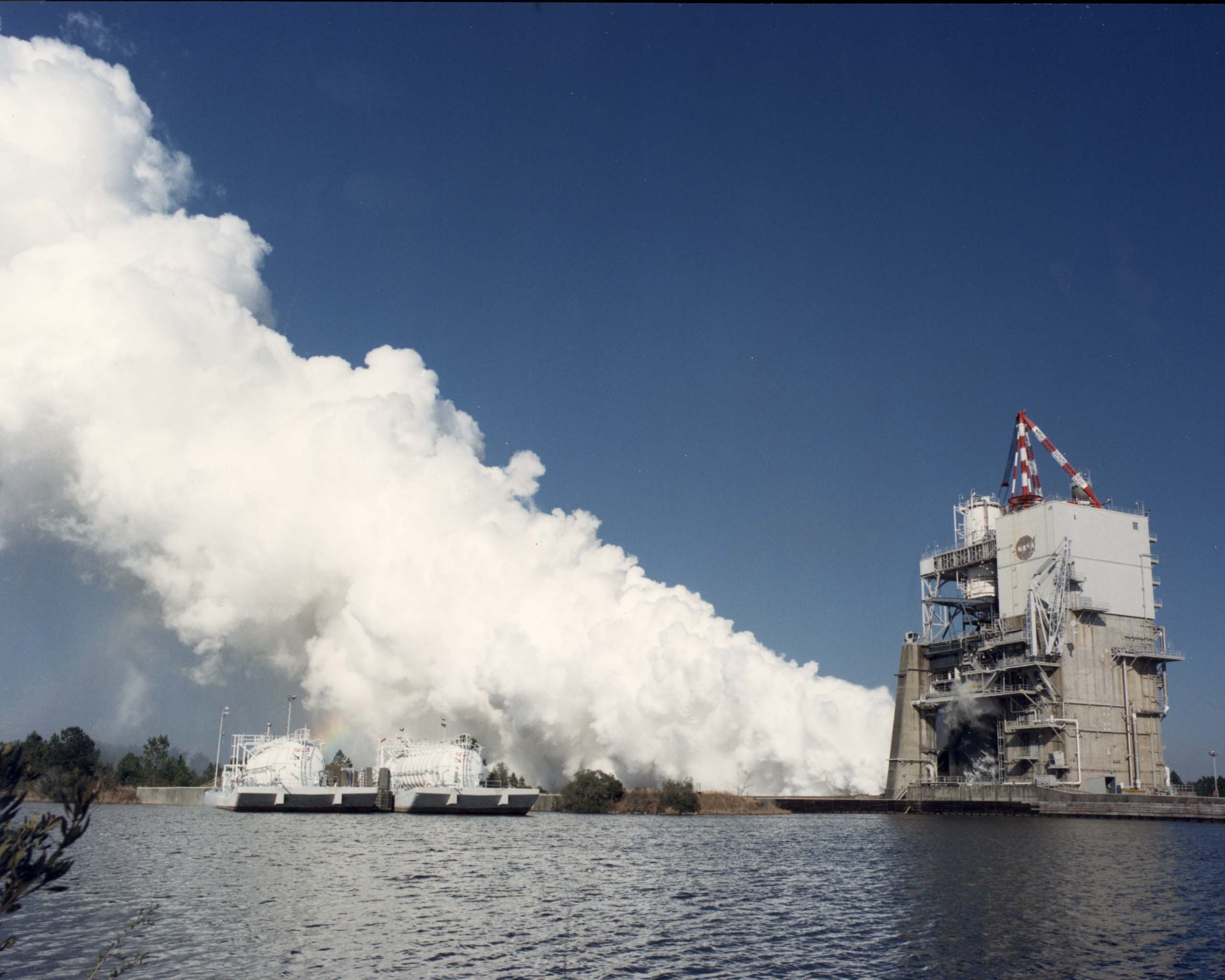 Clouds of steam billow out from the A-1 Test Stand during a test firing of a Space Shuttle Main Engine