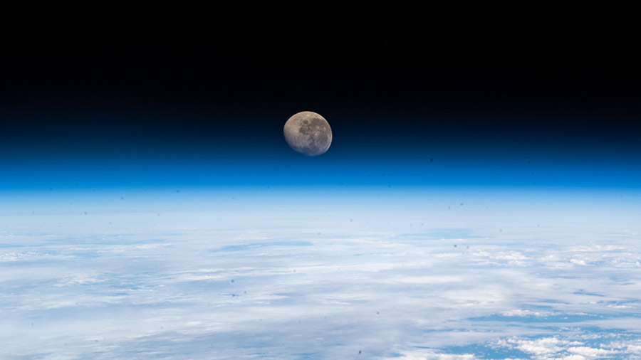 The waning gibbous Moon is pictured above the Earth's horizon from the International Space Station.