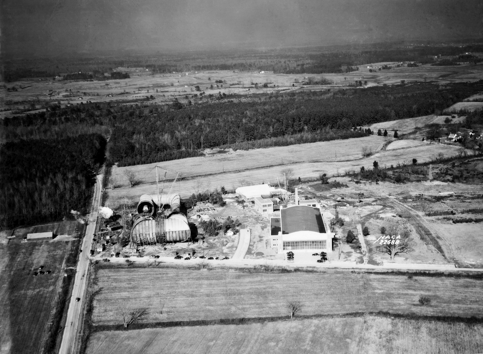 The ongoing construction of the 16-Foot Transonic Tunnel (on the left) can be seen in this aerial image from Jan. 4, 1941. NASA photo.