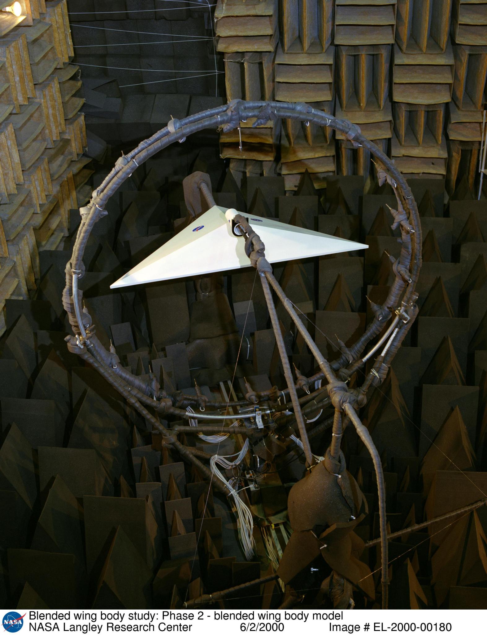 Blended Wing Body model installed inside the Langley Anechoic Noise Research Facility(B1218) in June 2000. A circular microphone boom that is used to measure noise around the model can also be seen.