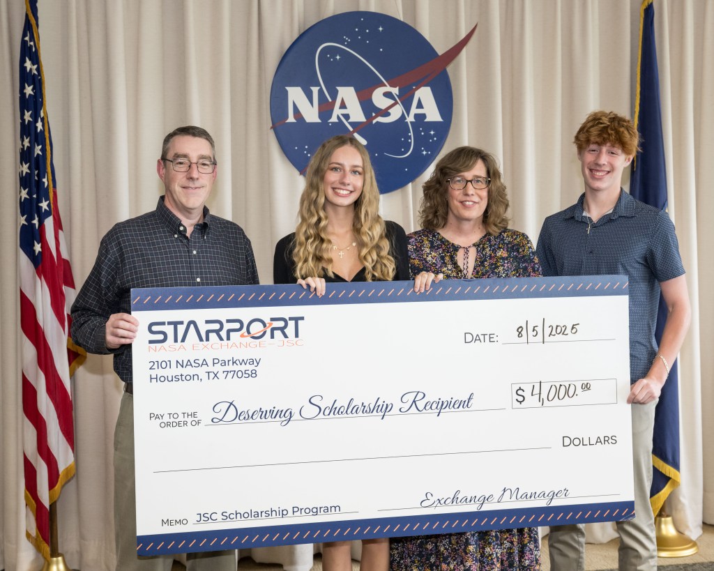 A group of individuals holding an oversized check.