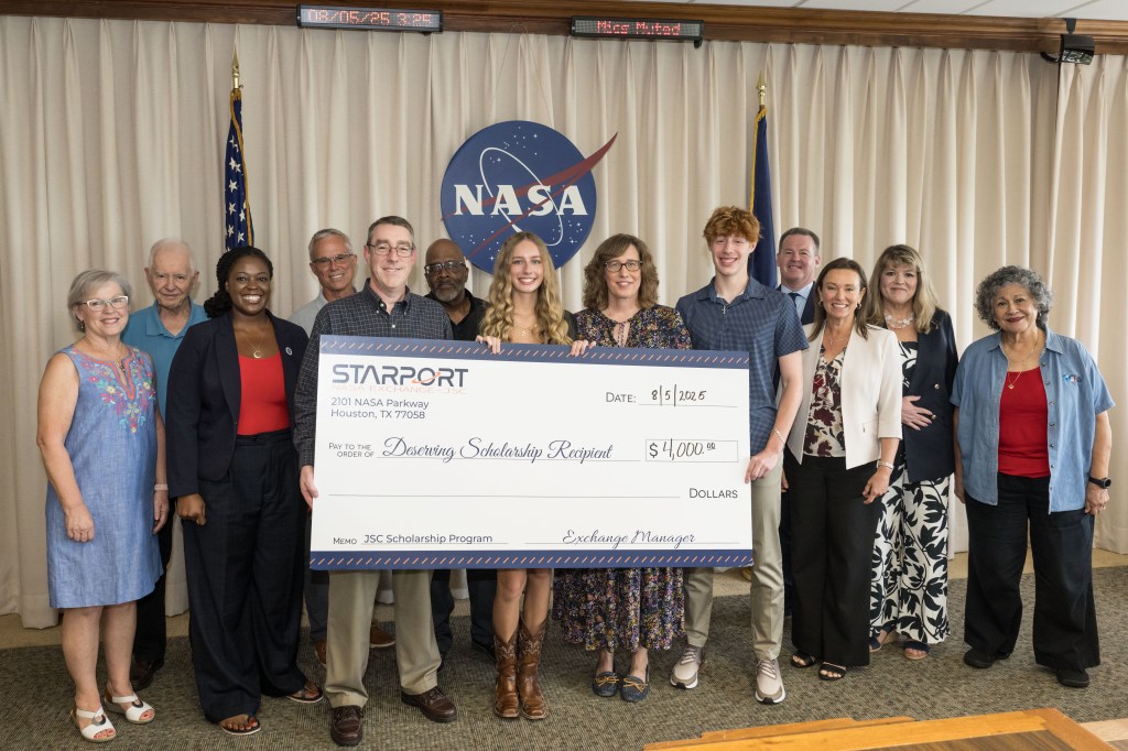 A group of individuals holding an oversized check.