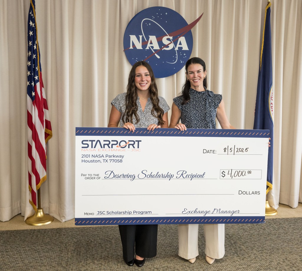 Two individuals holding an oversized check.