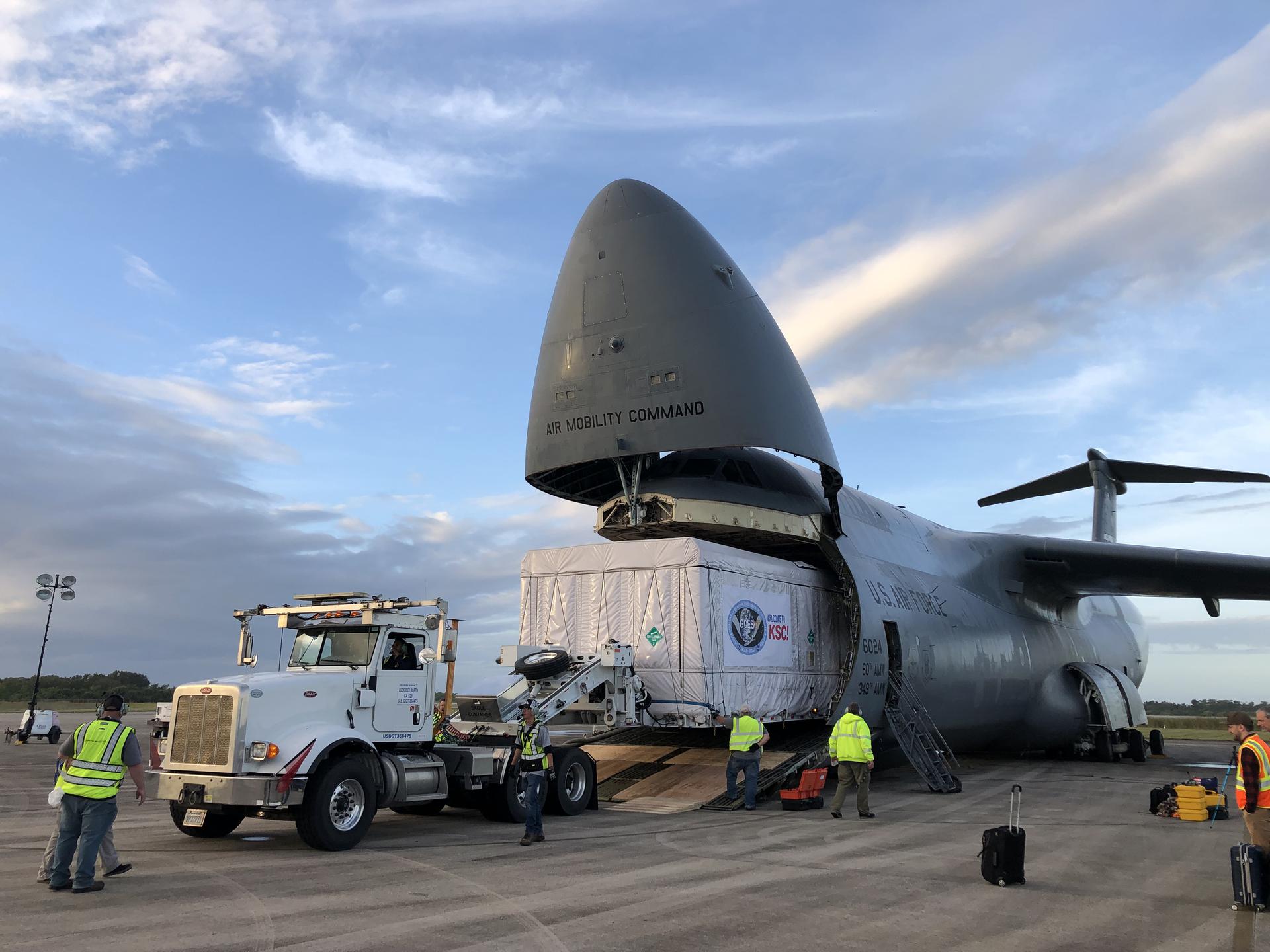 The shipping container holding the Geostationary Operational Environmental Satellite T (GOES-T) is unloaded from a cargo plane following its arrival at the Launch and Landing Facility runway at NASA’s Kennedy Space Center in Florida on Nov. 10, 2021.