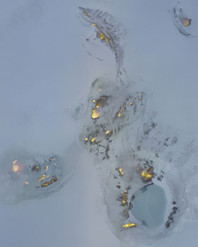 Aerial photograph of the summit of Makushin Volcano in Alaska, overlaid with thermal image data in yellow. 