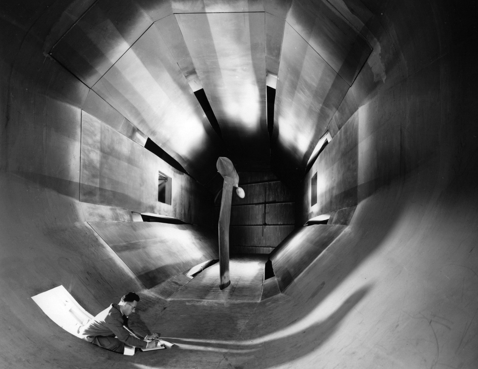 An engineer taking notes in the test section of the 16-Foot tunnel’s slotted-throat tunnel circa 1950.