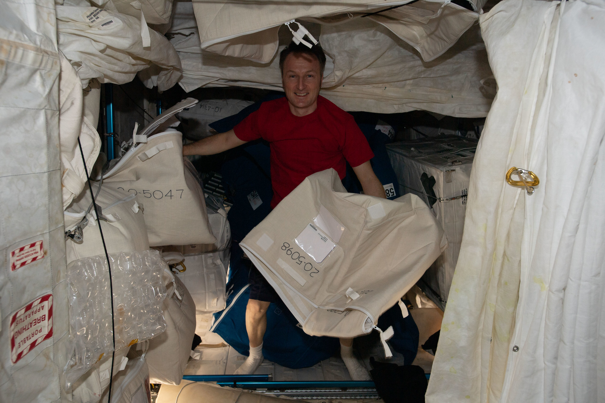 image of astronaut moving cargo bags