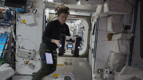 moving image of an astronaut working with a robot