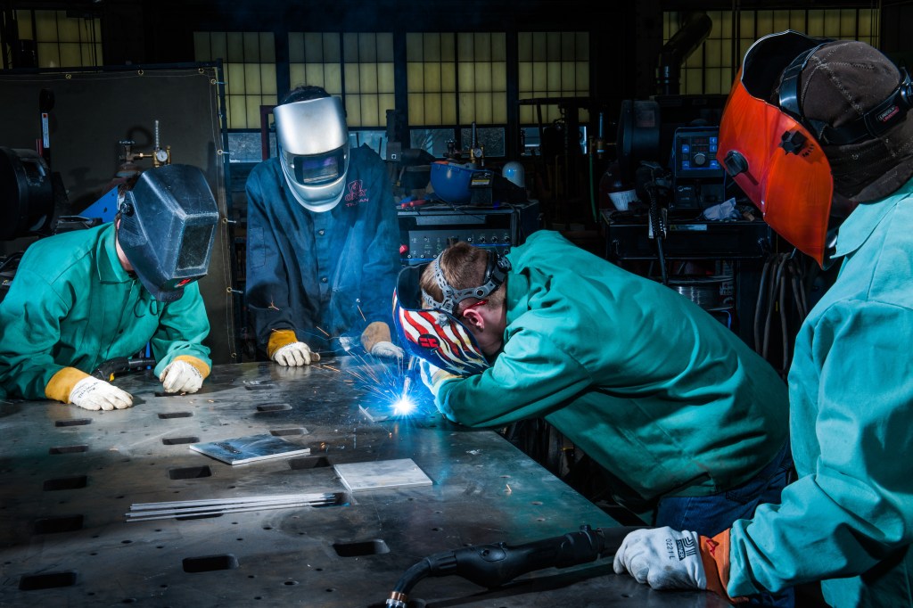 Students receive a tutorial in welding techniques from Senior Welder and Engineering Technician Tom Dixon at NASA Glenn