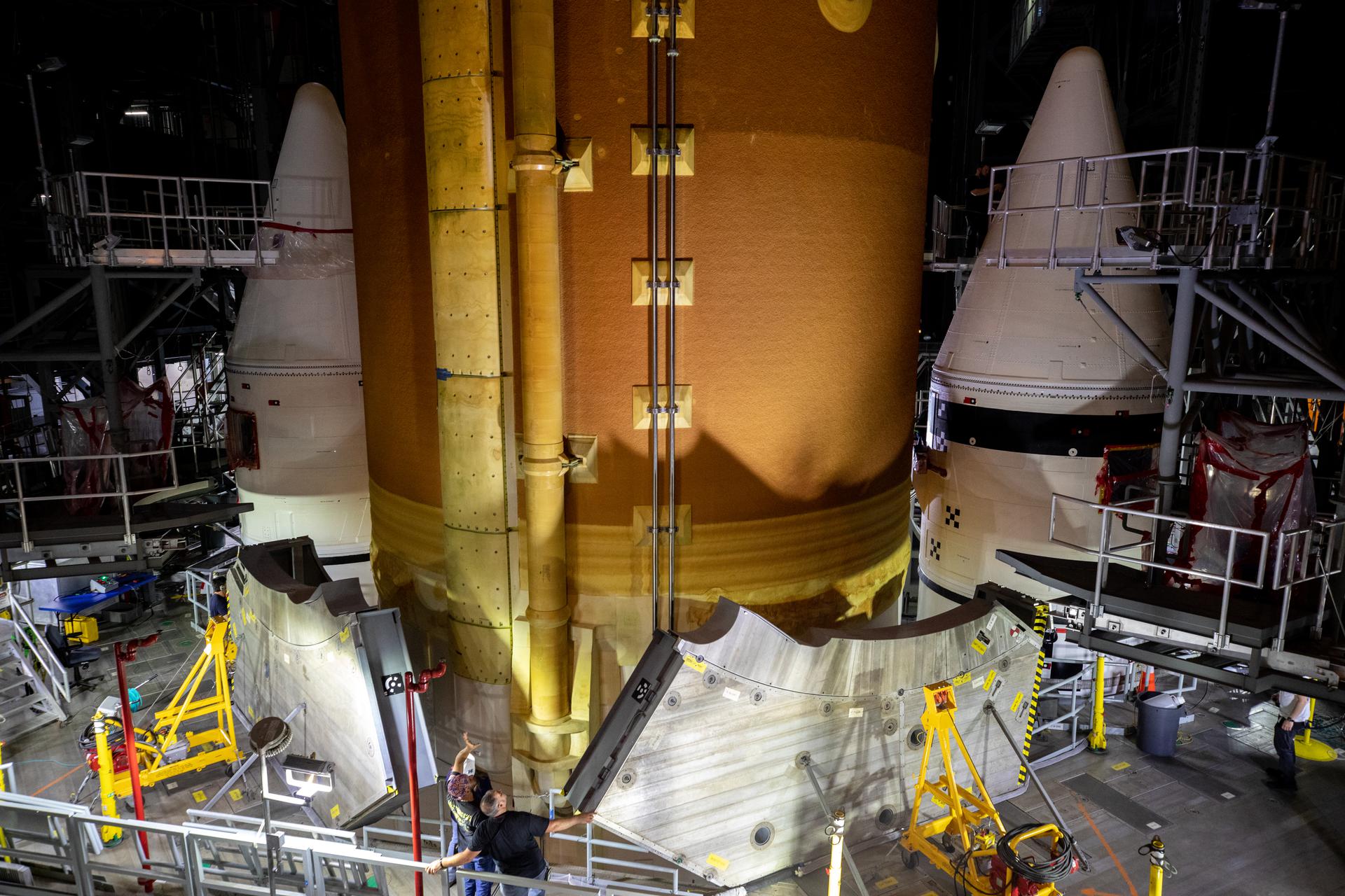 Teams with NASA’s Exploration Ground Systems and contractor Jacobs lower the Space Launch System core stage – the largest part of the rocket – onto the mobile launcher, in between the twin solid rocket boosters, inside High Bay 3 of the Vehicle Assembly Building at NASA’s Kennedy Space Center in Florida on June 12, 2021.