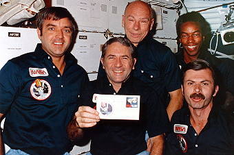 STS 8 crew on the flight deck of the space shuttle Challenger.