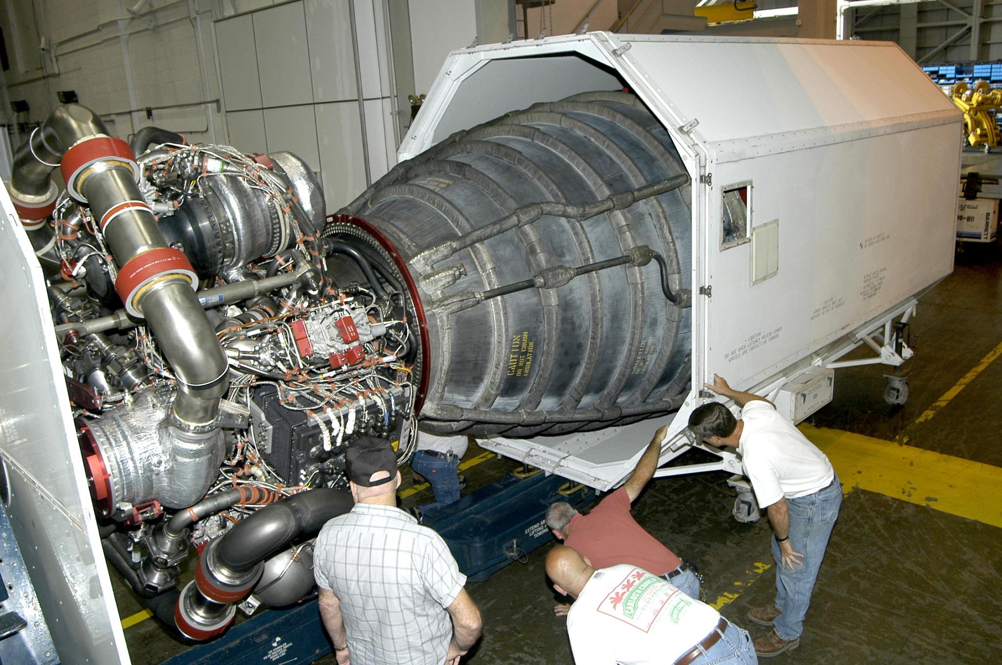 Stennis Space Center employees prepared a space shuttle main engine for transport to Kennedy Space Center on Oct. 4, 2004.