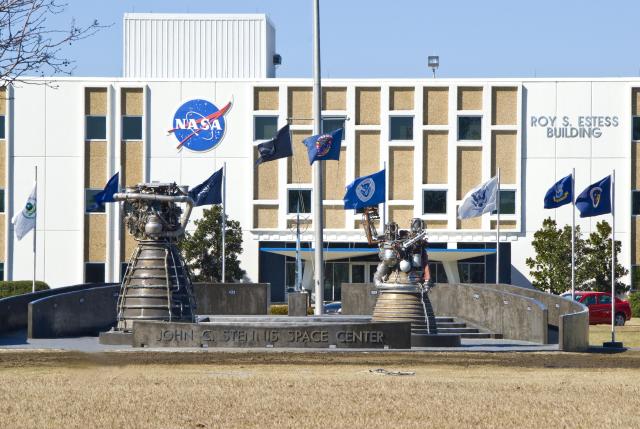 The front of the Roy S. Estess Building at Stennis Space Center with rocket engines on display