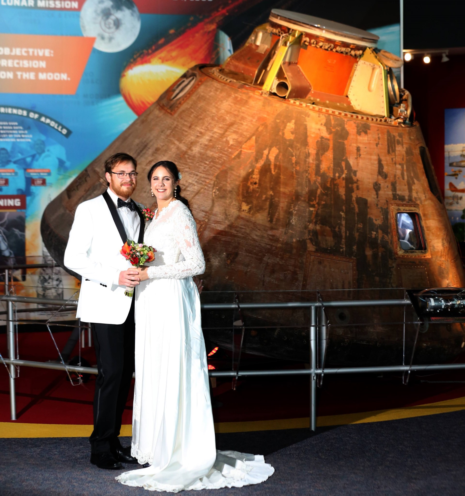 Jessica and Paul Friz were married at NASA Langley Research Center. For this wedding photo, they posed in front of the Apollo 12 Command Module from a mission to the Moon in November 1969.