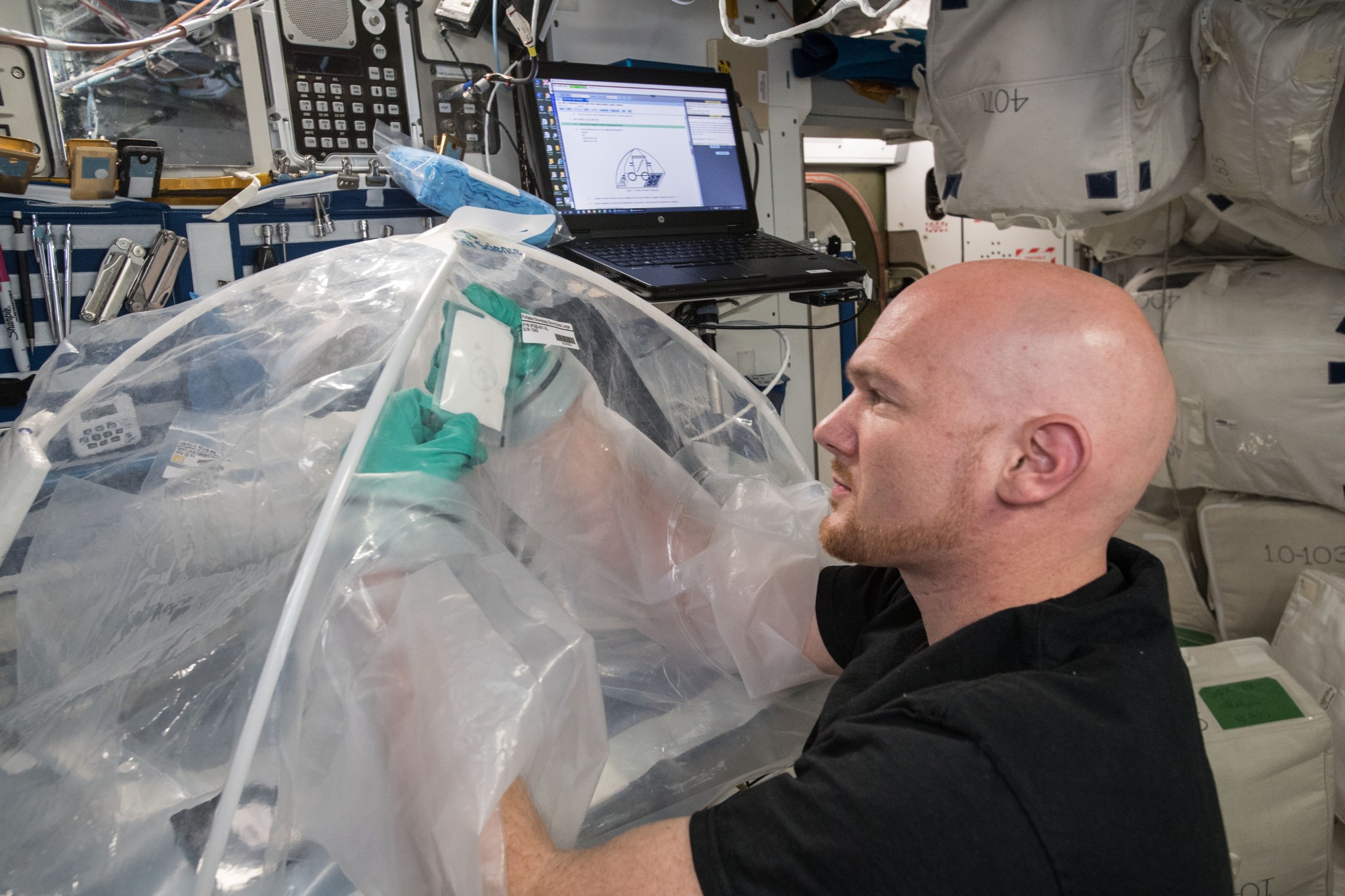 astronaut Alexander Gerst working in glovebox