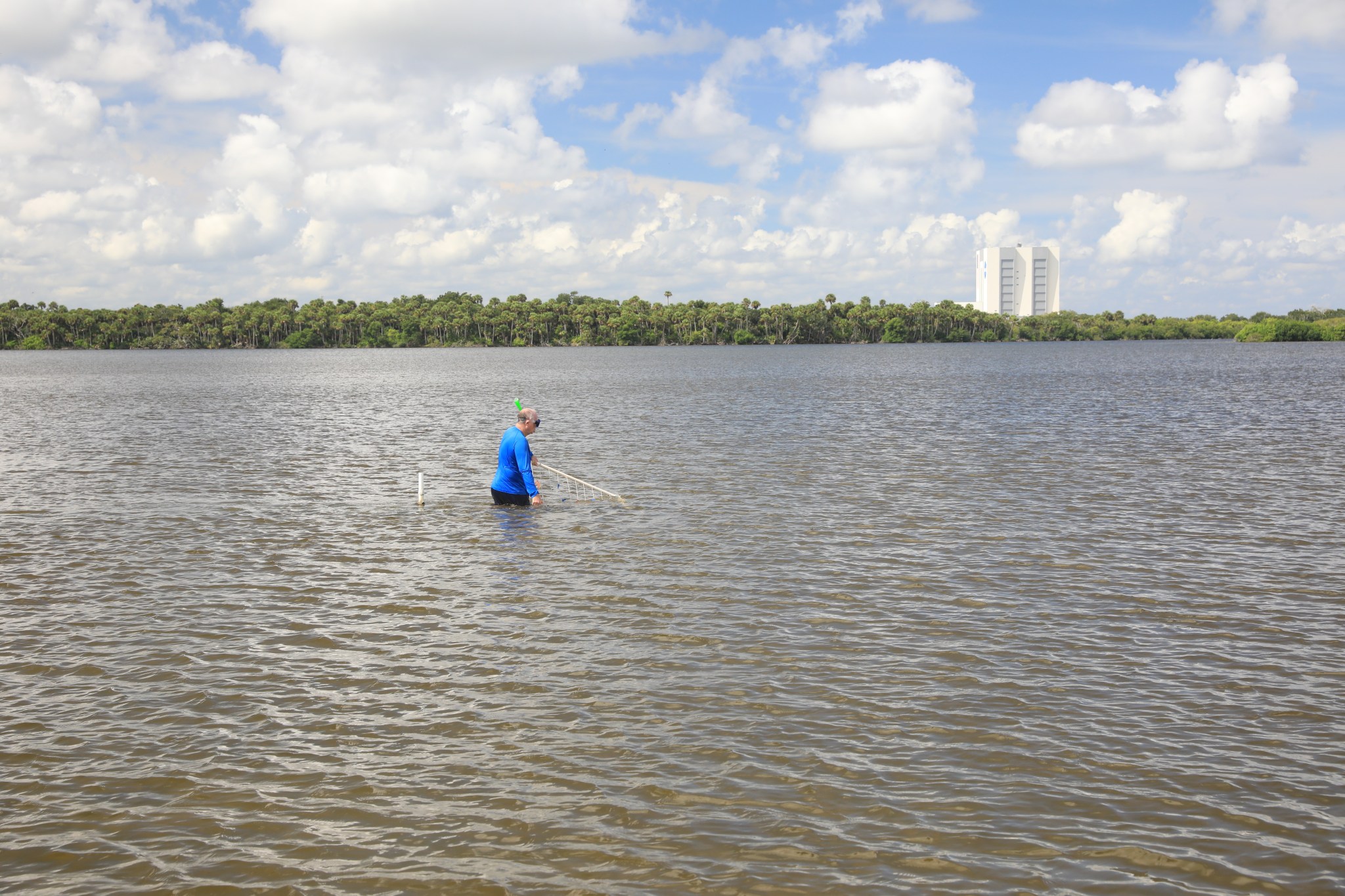 Aquatic biologist Doug Scheidt measures seagrass density at Pepper Flats, just south of the visitors gantry at Kennedy Space Center.
