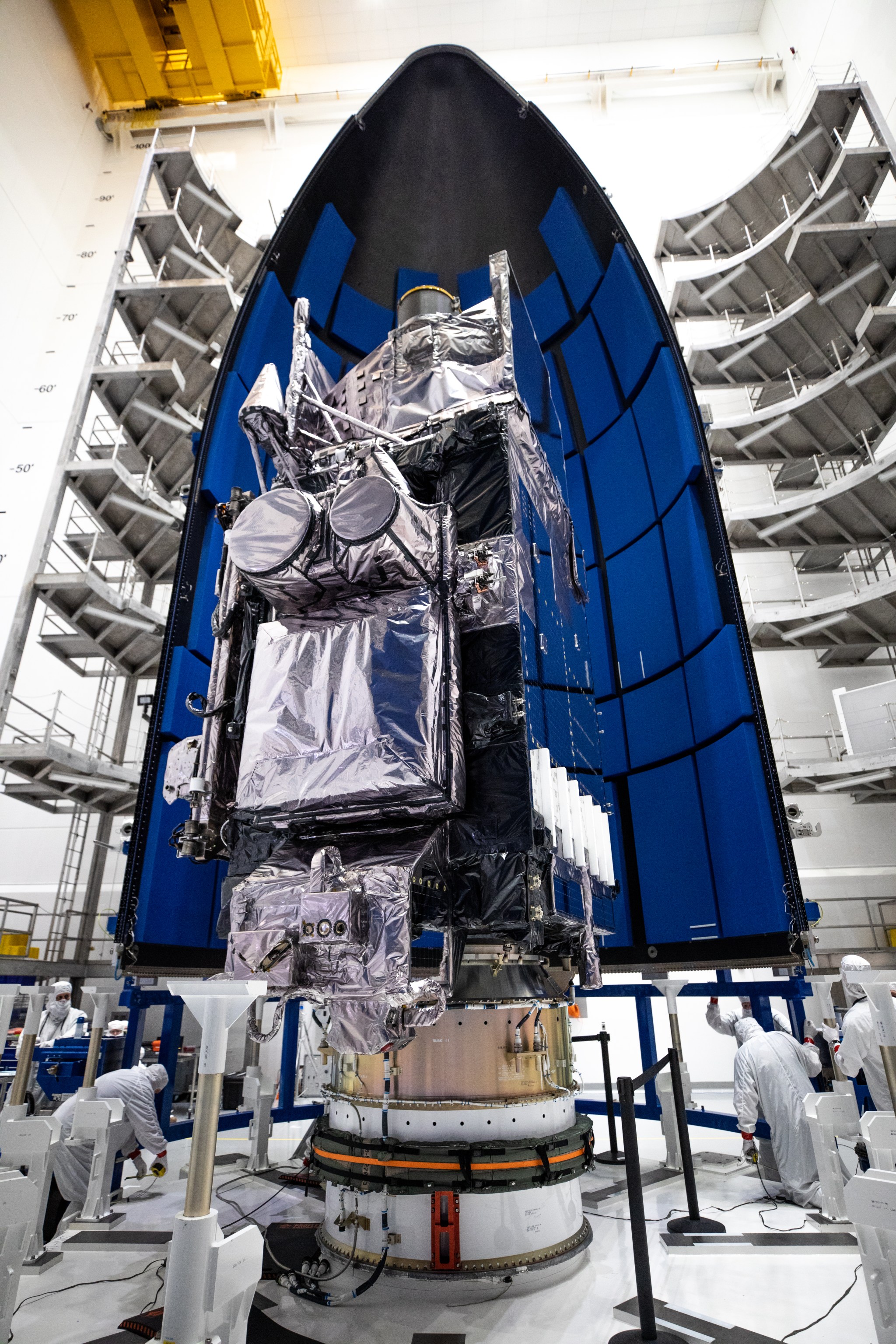 The first half of the United Launch Alliance Atlas V payload fairing is being secured around NOAA’s Geostationary Operational Environmental Satellite-T (GOES-T) inside the Astrotech Space Operations facility in Titusville, Florida, on Feb. 7, 2022.