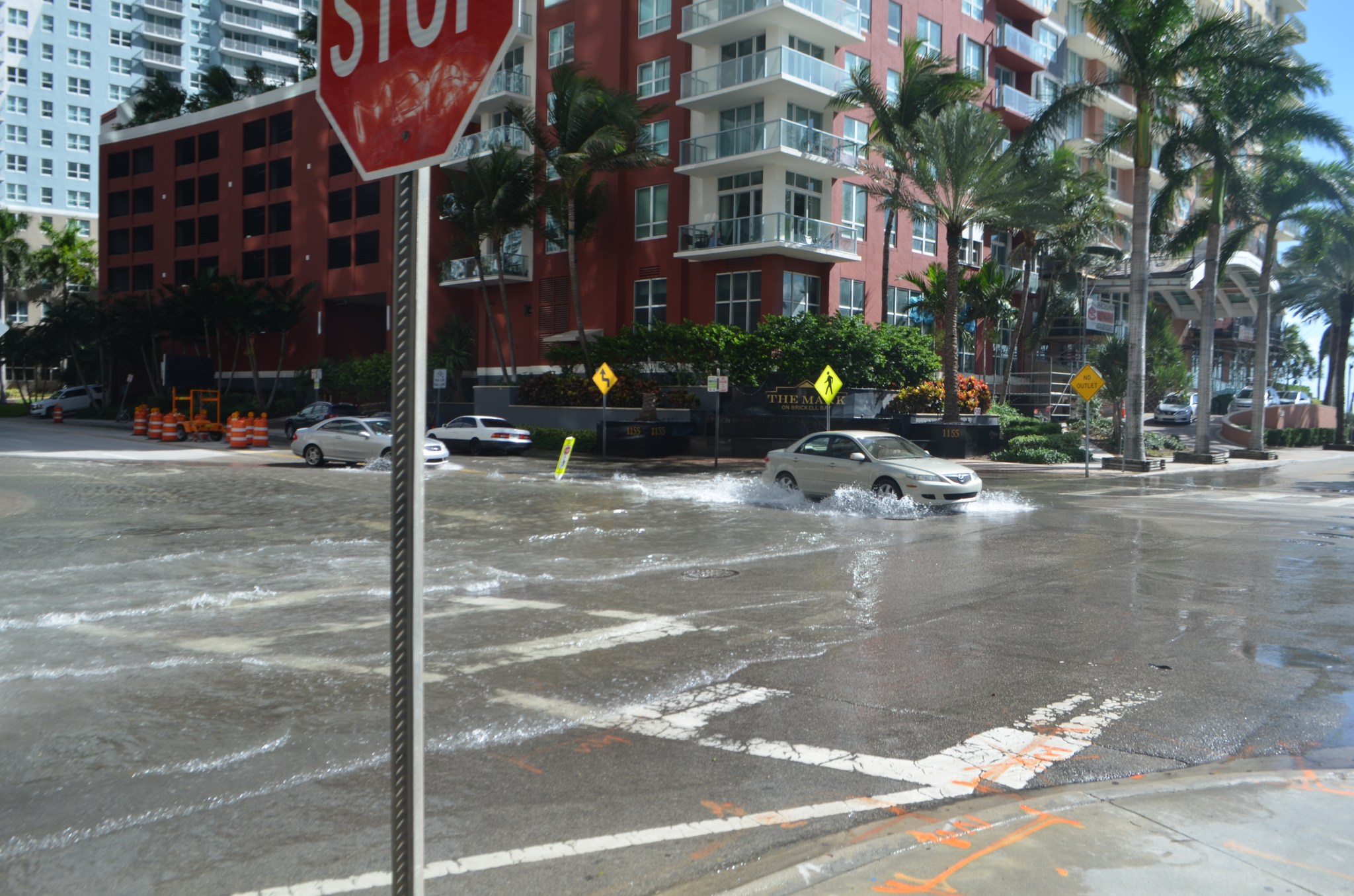 Cars driving through a flooded street in Miami