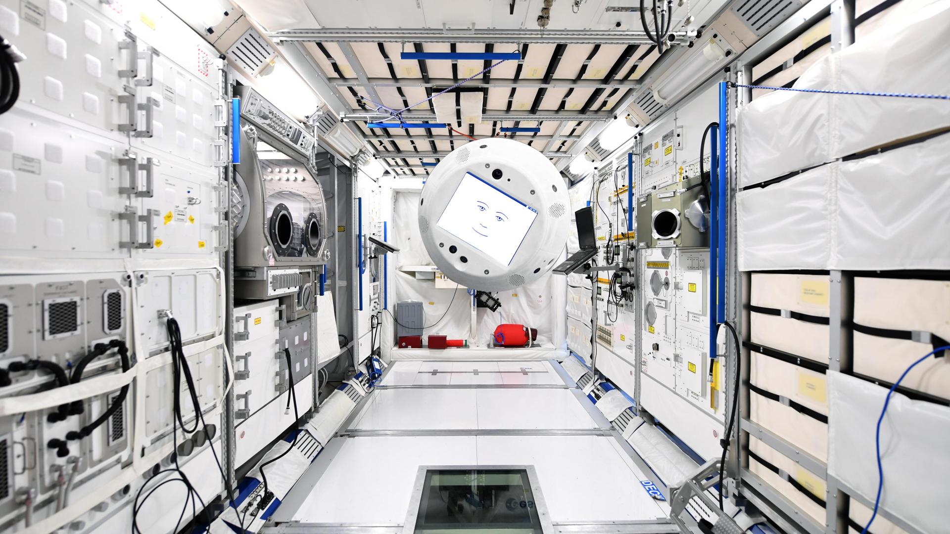 composite image of a robot floating in the station