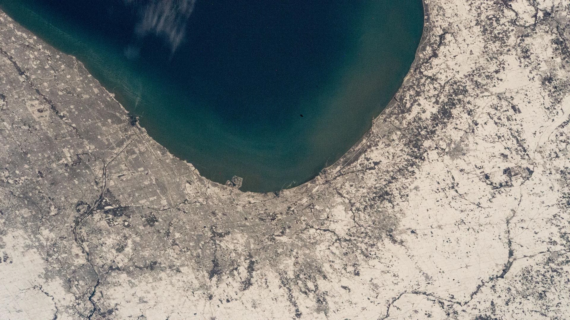 image of a lakeshore and land covered in snow