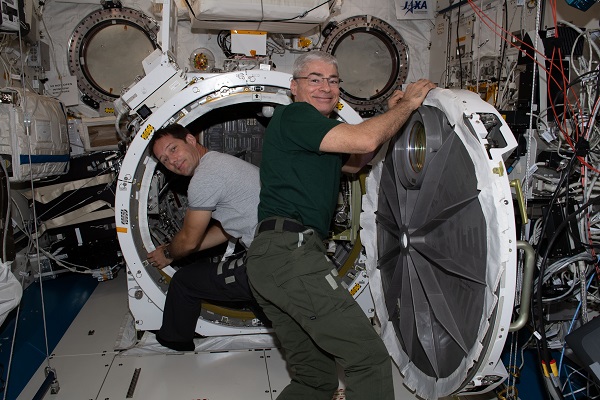 image of an astronaut working with hardware