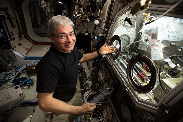 image of an astronaut working with science glove box