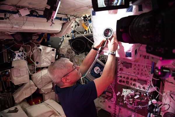 image of an astronaut working with an experiment