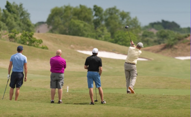 Four men playing golf
