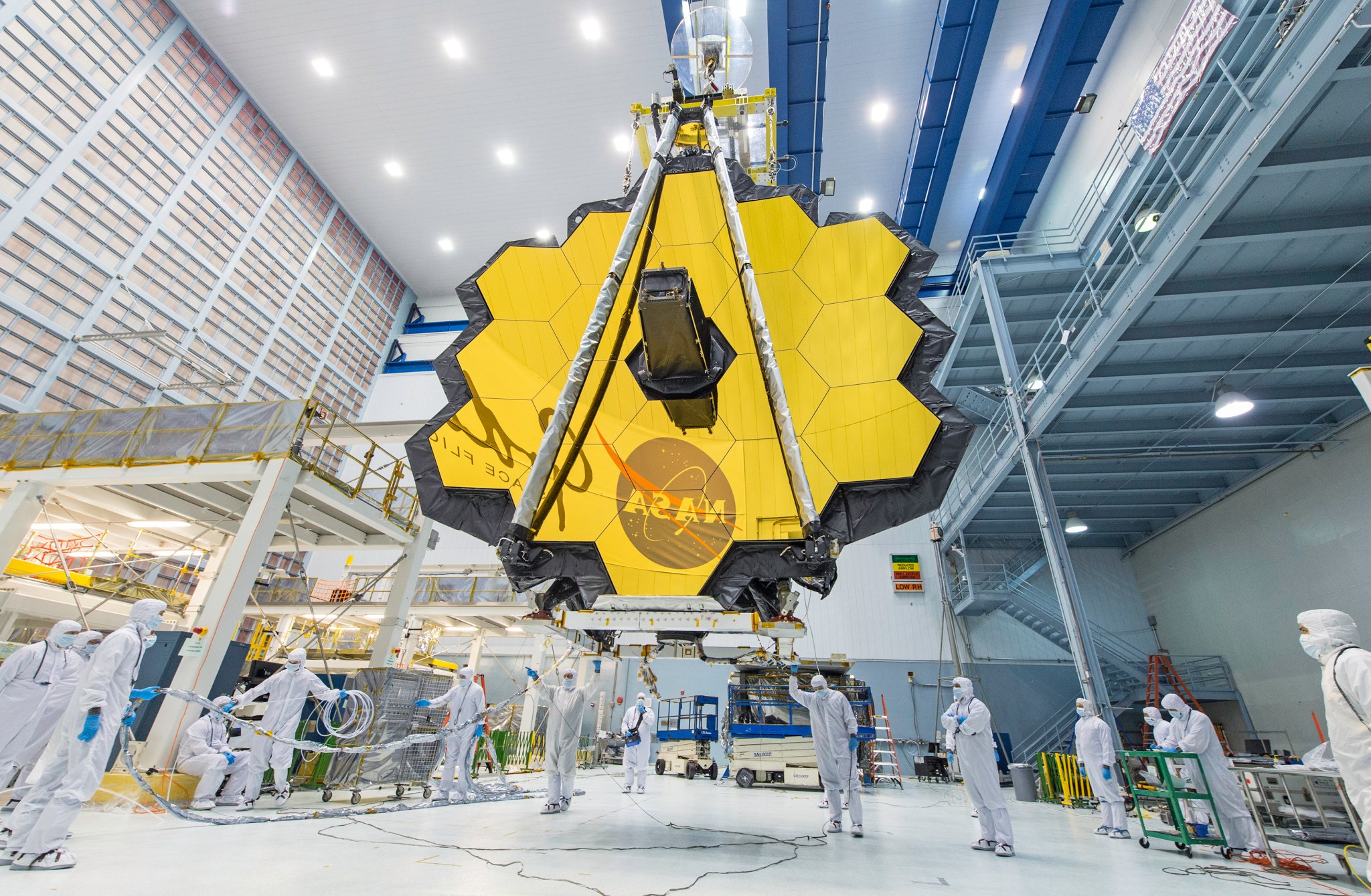 NASA technicians use a crane to lift and move the James Webb Space Telescope, with its 21-foot primary mirror deployed, inside a clean room at NASA’s Goddard Space Flight Center in Greenbelt, Maryland, in April 2017.