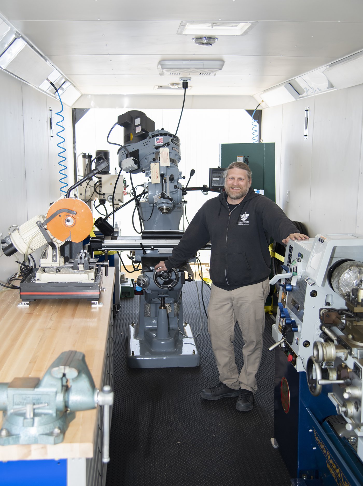 Jason Nelson surrounded by tools inside of the trailer.