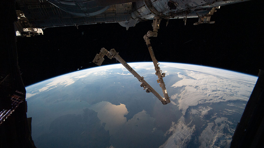 The Canadarm2 robotic arm is pictured extending from the space station as it orbited above Ireland and the United Kingdom.