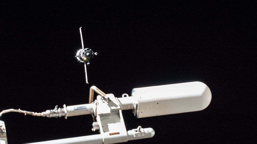 The Soyuz MS-21 crew ship (upper left) with three cosmonauts aboard approaches the space station for a docking on March 18.