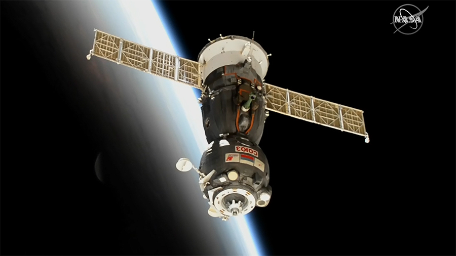 The Soyuz MS-19 crew ship with three Expedition 66 crew members backs away from the station as both spacecraft orbit into a sunrise above the Atlantic Ocean.