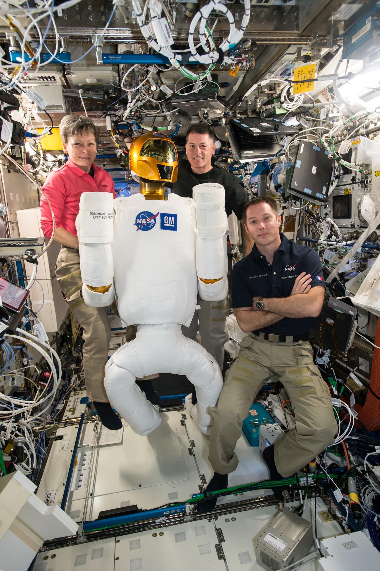 Peggy Whitson, Shane Kimbrough, and European Space Agency (ESA) astronaut Thomas Pesquet posing with Robonaut in the U.S. Laboratory.