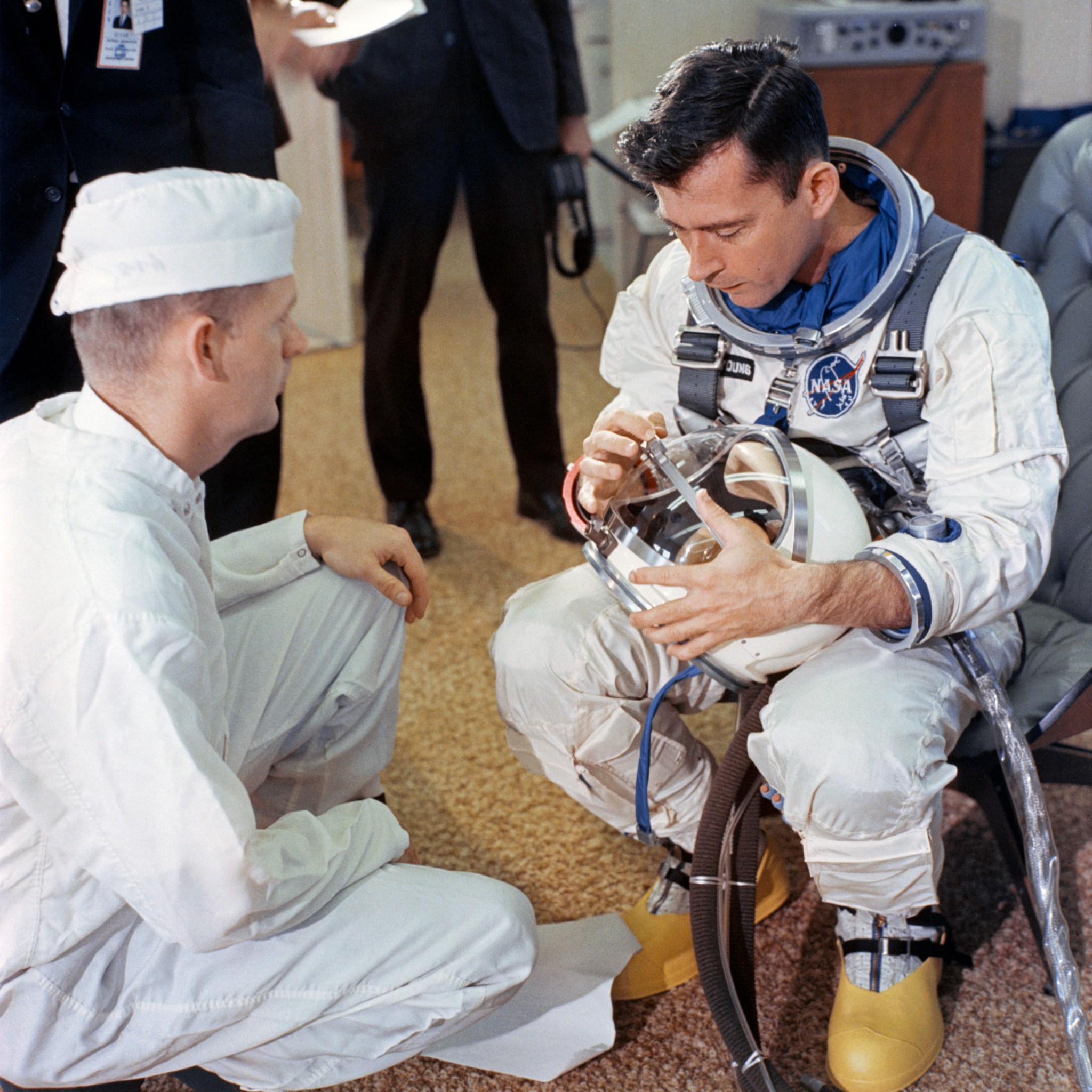 An astronaut inspects his helmet in the ready room in preparation for the launch.