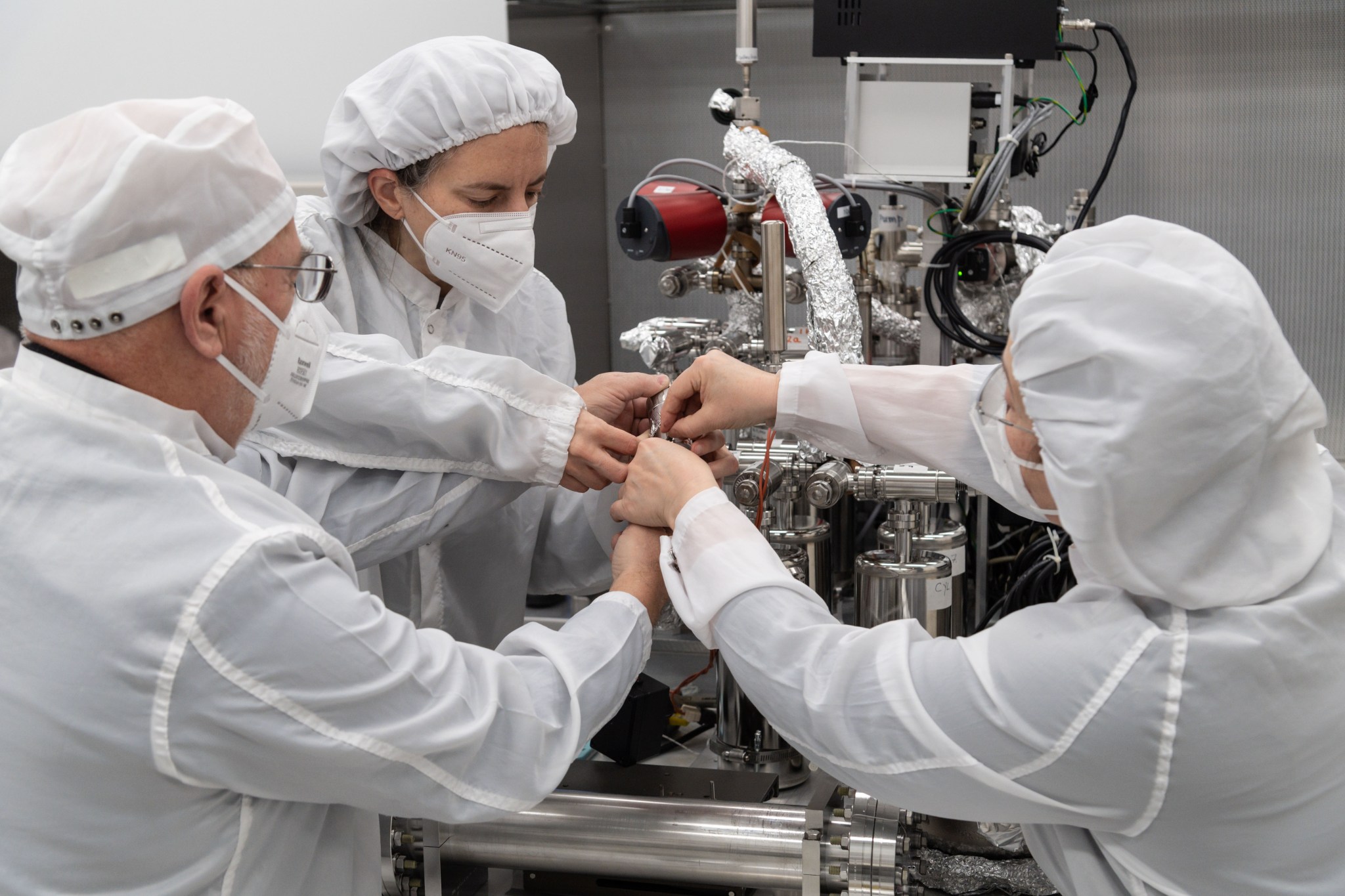 From left, Dr. Juliane Gross, Astromaterials Research and Exploration Science Division deputy Apollo curator, Drs. Alex Meshik, and Olga Pravdivtseva, from the Washington University in St. Louis, begin a gas extraction process using the manifold. 