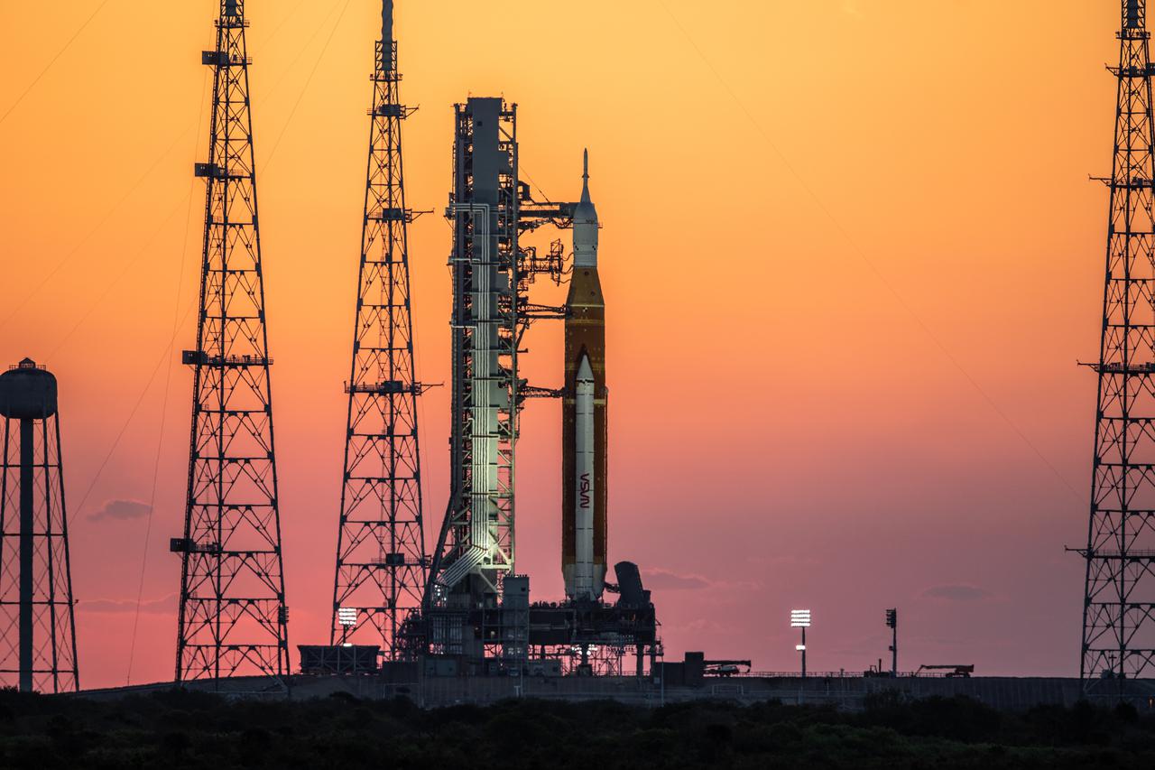 The sunrise casts a warm glow around the Artemis I Space Launch System (SLS) and Orion spacecraft at Launch Pad 39B at NASA’s Kennedy Space Center in Florida on March 21, 2022.