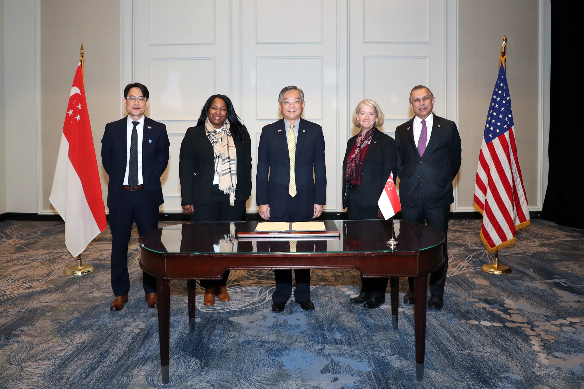 Officials from NASA, the U.S. State Department, and the Singapore Ministry of Communications and Information pose for a photo following Singapore's signing of the Artemis Accords in Washington, March 28, 2022.