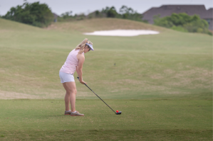 Golf player preparing to hit the ball