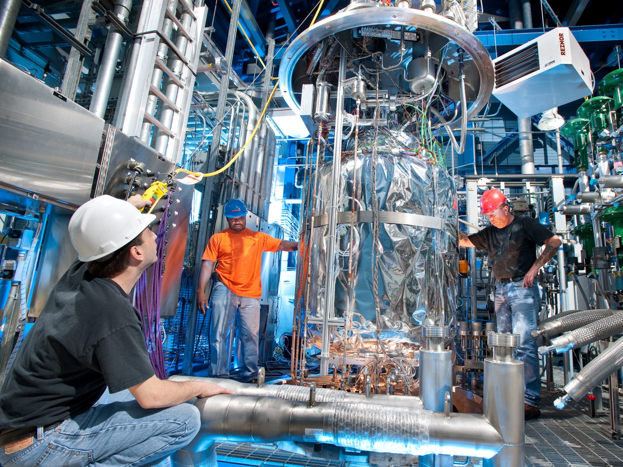  Three men working at the Small Multi-Purpose Research Facilityn (SMiRF)