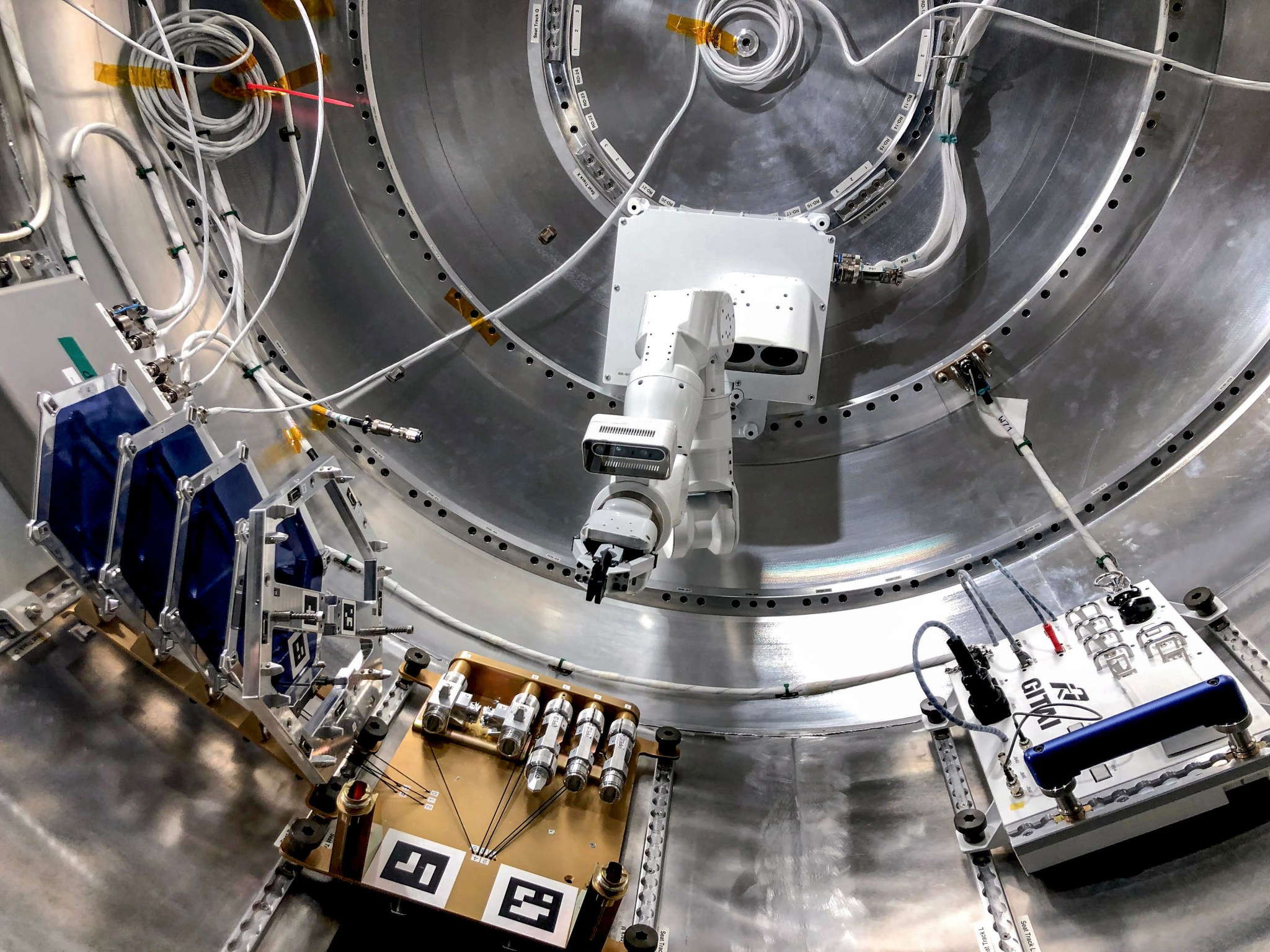 image of a robotic arm in an airlock