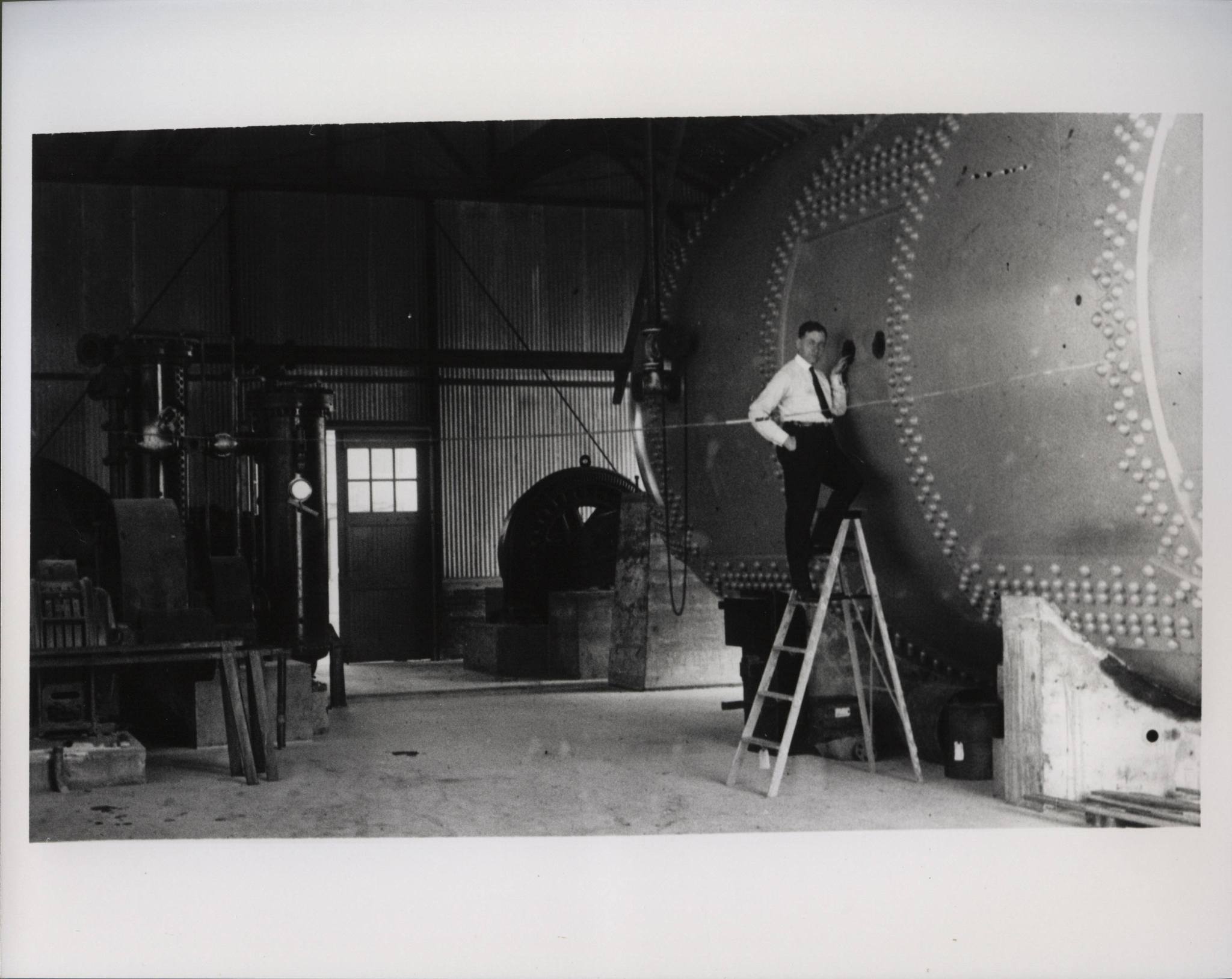 This is a photo of Dr. Max Munk, known for conceiving, developing, and placing into operation the Variable Density Tunnel (VDT), inspecting the VDT after its installation in Building 582. This image, copied from a 7mm film roll, was originally shot in May of 1922.
