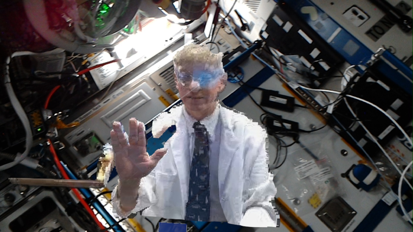 NASA flight surgeon, Dr. Josef Schmid gives a space greeting Oct. 8, 2021, as he is holoported on to the International Space Station.