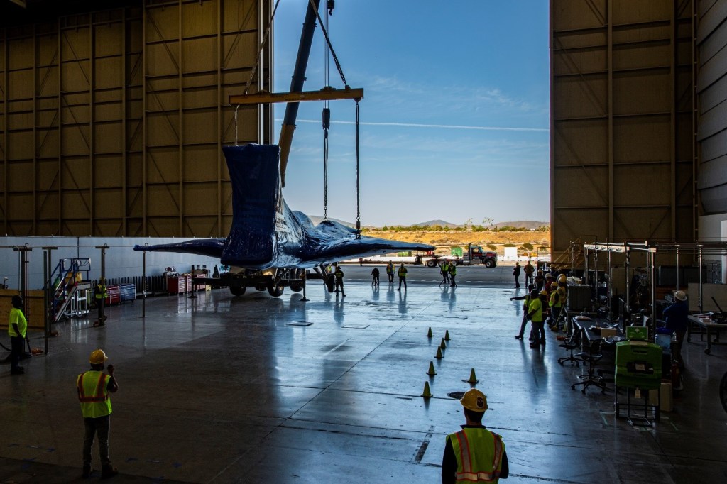 Aircraft entering a hangar.