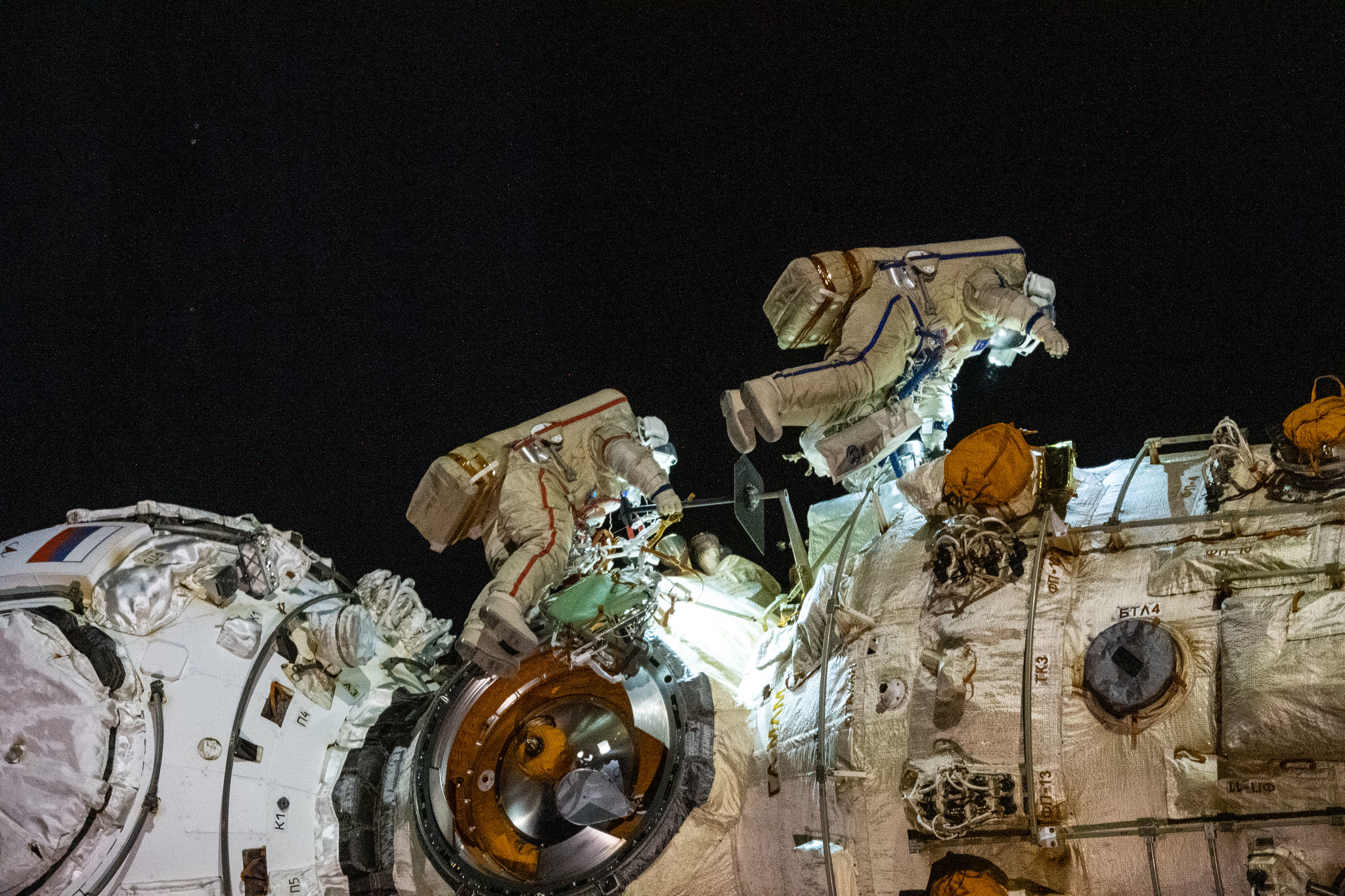 Cosmonauts Anton Shkaplerov (left) and Pyotr Dubrov (right) work to outfit the Nauka multipurpose laboratory module during a seven-hour and 11-minute spacewalk Jan. 19, 2022.