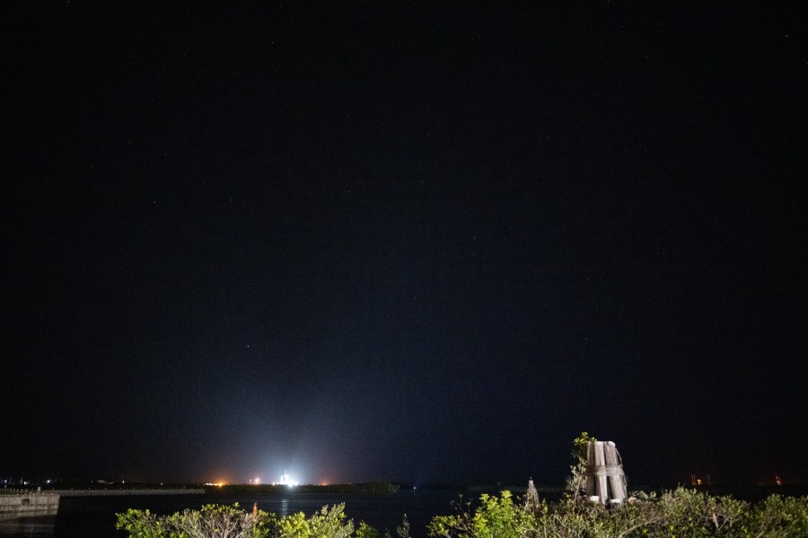 A SpaceX Falcon 9 rocket with the company's Crew Dragon spacecraft onboard is seen illuminated by spotlights on the launch pad at Launch Complex 39A as preparations continue for the Crew-4 mission, Tuesday, April 26, 2022, at NASA’s Kennedy Space Center in Florida.