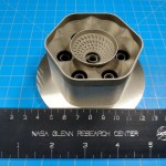 closeup of a 3-d printed part on a blue background