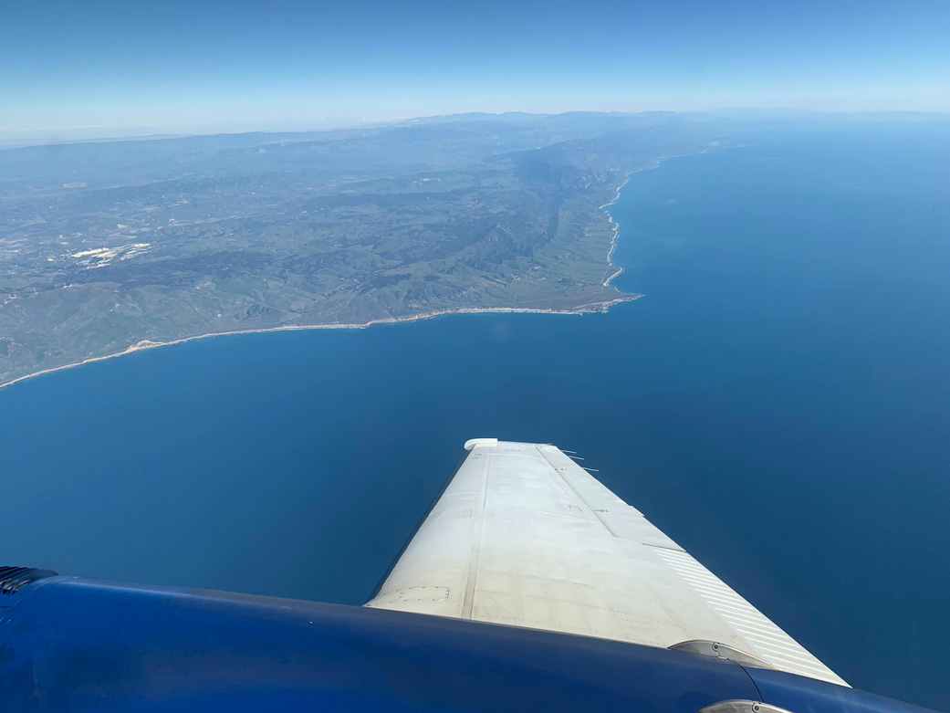 A research plane collecting spectral imaging data of vegetation on land and in the ocean as part of the SHIFT campaign flies just off the Central Coast of California near Point Conception and the Jack and Laura Dangermond Preserve in February.