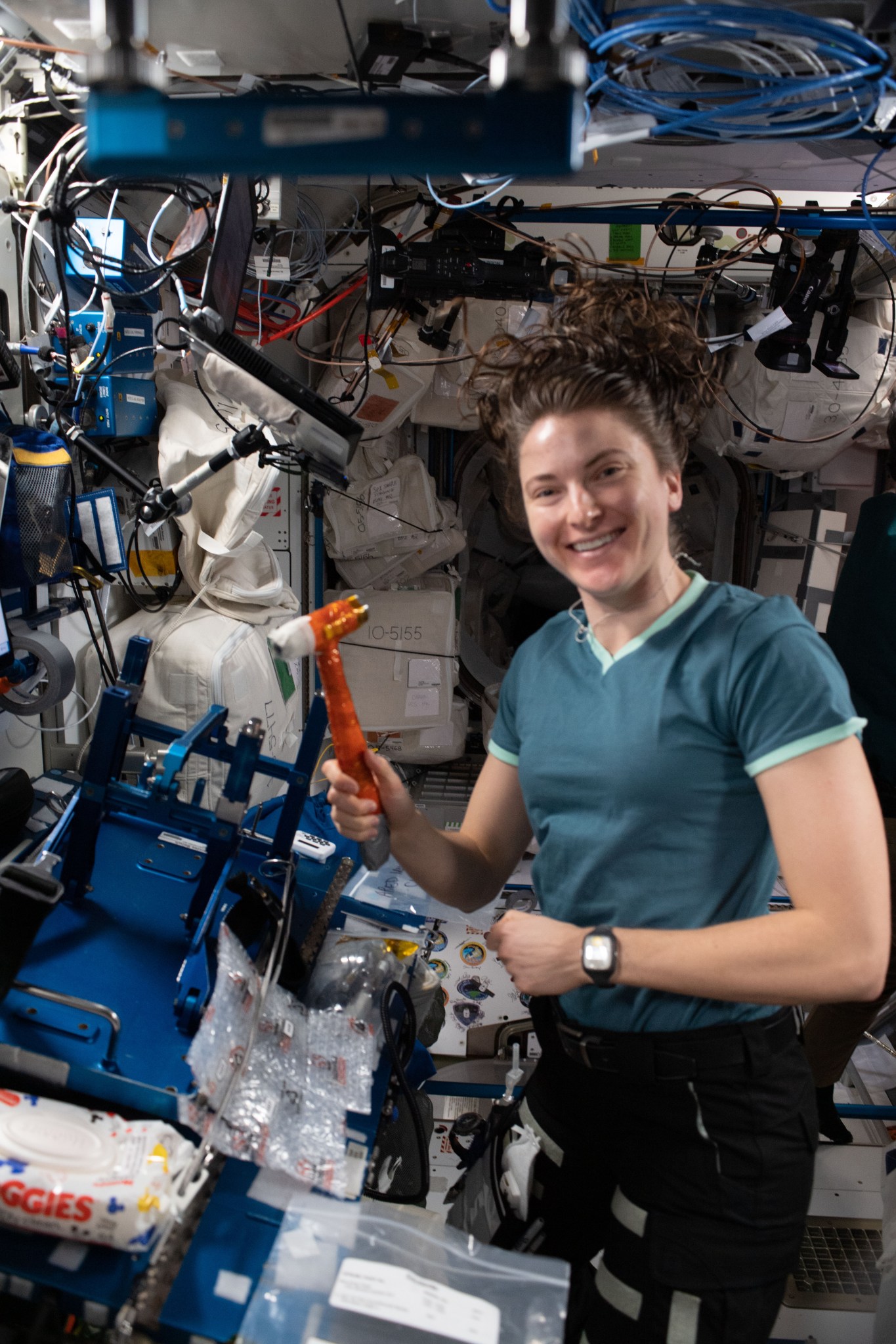 NASA astronaut Kayla Barron works stowing items aboard the space station