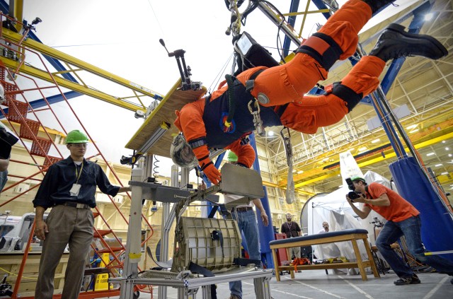 NASA Astronaut Rex Walheim participates in an evaluation of the Advanced Crew Escape Suit (ACES) in the Active Response Gravity Offload System (ARGOS) at the Johnson Space Center.